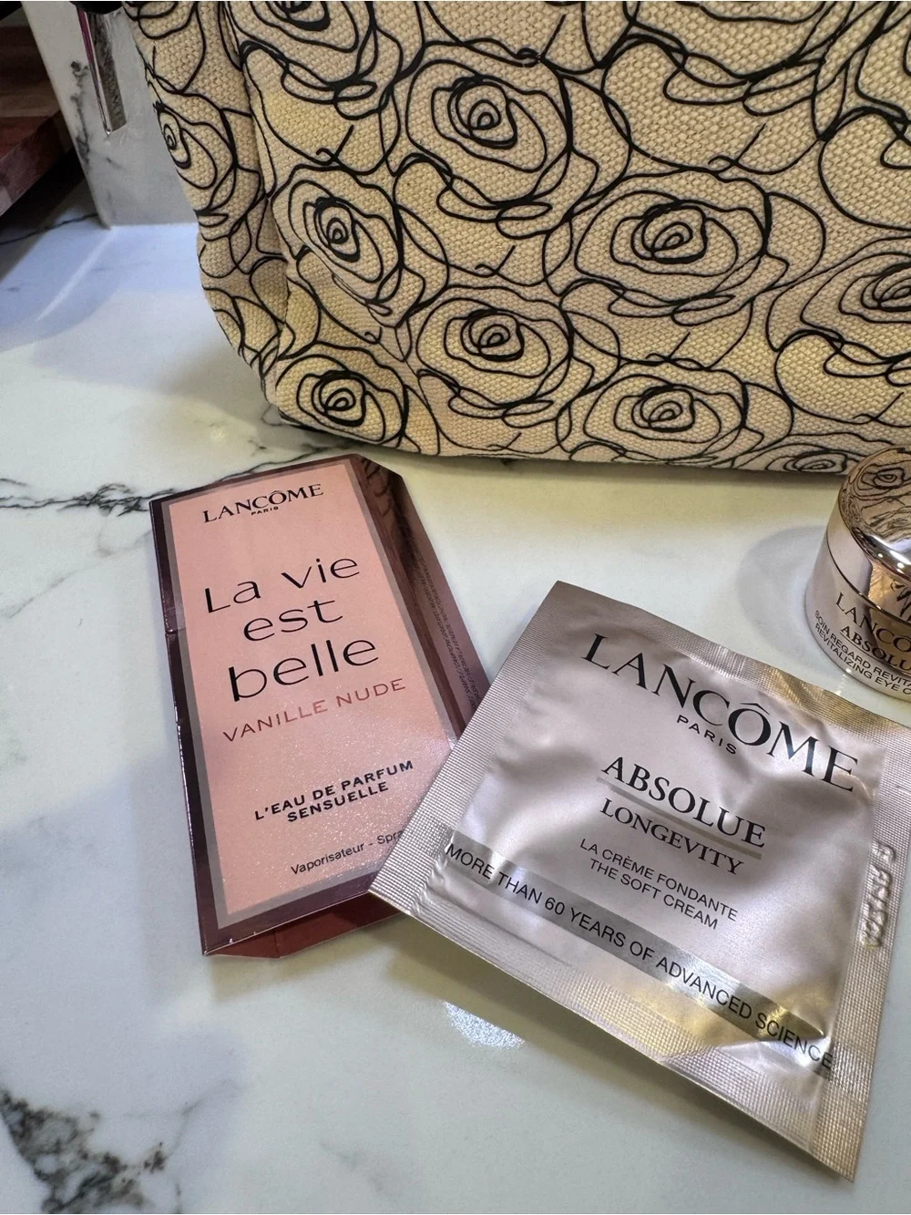NWOT Lancome Floral Canvas Cosmetic Bag in Cream and Black with skincare minis